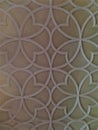 White quatrefoil trim on cream ceiling