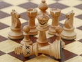 White queen kills white king on chess game, chess crime scene, concept of treachery Royalty Free Stock Photo