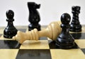 The white queen was defeated by two pawns  on chess board Royalty Free Stock Photo