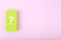 White question mark on green rectangle against colored bright purple background with copy space Royalty Free Stock Photo