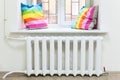 White radiator of central heating in domestic room under window Royalty Free Stock Photo