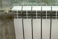 White radiator heating on a green wall background Royalty Free Stock Photo