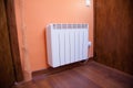 White radiator orange wall