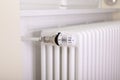 White radiator with white thermostat