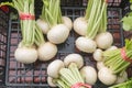 White radishes on black basket