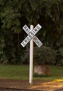 White railroad crossing sign at sunset Royalty Free Stock Photo