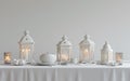 a white ramadan table setting with three lanterns, three candles and a white room background Royalty Free Stock Photo