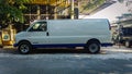 White rare GMC Savana that already converted to right hand drive parked on the side of the road