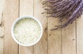 White raw rice and purple paddy rice on wood background