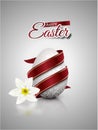 White realistic egg with silver metallic floral pattern diagonal wrapped red ribbon. Gray background with reflection