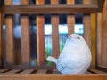 White realistic mortar bird sculpture decoration on wooden background