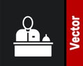 White Receptionist standing at hotel reception desk icon isolated on black background. Vector Royalty Free Stock Photo