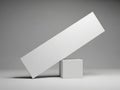A white rectangular block balanced on a smaller cube against a gray background Royalty Free Stock Photo