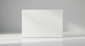 A white rectangular block stands on a smooth, light-colored surface. Soft shadows