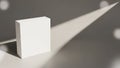 White rectangular box casting a long shadow on a gray surface with light circles packaging Royalty Free Stock Photo