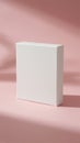 White rectangular box placed on a soft pink background with minimalistic lighting Royalty Free Stock Photo