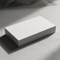 White rectangular box resting on a textured gray surface possibly concrete Royalty Free Stock Photo