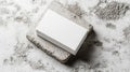White Rectangular Box on Rough Stone Block with Mottled Gray Background Royalty Free Stock Photo