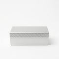 White rectangular box with textured top on plain background Royalty Free Stock Photo