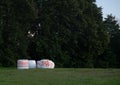 White, rectangular boxes with red patterns situated outdoors in a field against a bright, blue sky Royalty Free Stock Photo