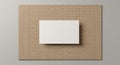 A white rectangular card is placed on a larger rectangular textured beige surface. The Royalty Free Stock Photo