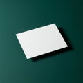 A white rectangular card is placed at a slight angle on a dark green textured background Royalty Free Stock Photo