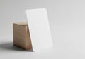 A white rectangular card with rounded corners is propped against a wooden cube. The Royalty Free Stock Photo