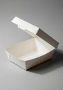 A white, rectangular cardboard takeout box sits open on a gray surface. The box has Royalty Free Stock Photo