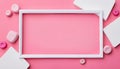 A white rectangular frame rests on a soft pink background, surrounded by play doh shapes in white and pink, creating a