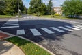 White rectangular intermittent crosswalk markers painted on the asphalt road in a residential neighborhood Royalty Free Stock Photo