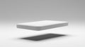 A white rectangular object is floating in mid-air against a gray background. Royalty Free Stock Photo