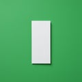 White rectangular object placed vertically on a bright green background. The object Royalty Free Stock Photo