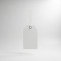 A white, rectangular paper tag with a rounded top hangs from a thin, white string. The Royalty Free Stock Photo