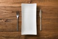 White rectangular Plate with fork and knife on brown wooden back