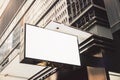 White rectangular sign with blank space for your logo on the wall of a modern shopping center, mockup