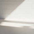 White rectangular tiles cover a wall, arranged in a clean, linear pattern. Light casts geometric Royalty Free Stock Photo