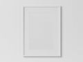 White rectangular vertical frame hanging on a white wall mockup