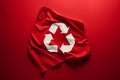 White recycle symbol printed on red fabric isolated on the red monochrome background. Ecology and environmental Royalty Free Stock Photo