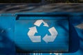 White recycling sign on the blue recycle bin Royalty Free Stock Photo