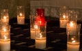 White and red candles in church. Glowing candles with burning flame. Faith and religion concept. Church decoration. Royalty Free Stock Photo