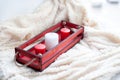 White, red candles, a red wooden box on a beige blanket. Royalty Free Stock Photo