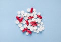White and red capsules and tabletson blue background Royalty Free Stock Photo
