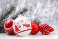 White and Red Christmas ornaments and fir tree branch on glitter bokeh background with space for text. Xmas and Happy New Year Royalty Free Stock Photo