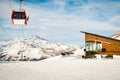 White red closed ski lift cabin with skiers and white dramatic snowy mountains background. Ski resort reopens. Georgia winter Royalty Free Stock Photo
