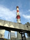 White and red concrete chimney and part of dedusting system Royalty Free Stock Photo