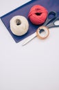 white and red decorative yarn balls on blue paper with stationery Royalty Free Stock Photo