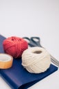 white and red decorative yarn balls on blue paper with stationery Royalty Free Stock Photo