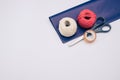 white and red decorative yarn balls on blue paper with stationery Royalty Free Stock Photo