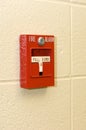 White and red fire alarm on a stone wall under the lights Royalty Free Stock Photo