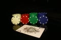 White, red, green, blue pocker chips stack with four  chips and an ace card in front isolated on black with reflection Royalty Free Stock Photo